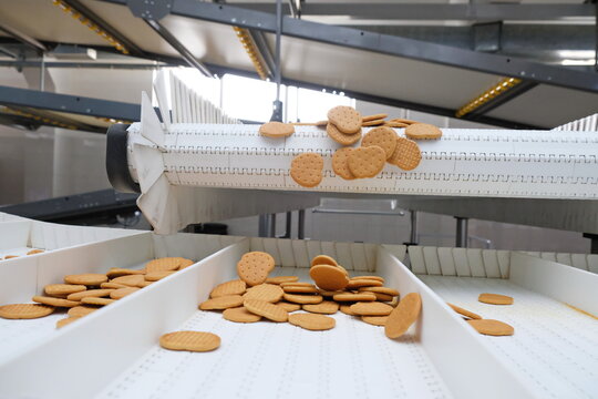 Shymkent, Kazakhstan - 03.12.2020 : Rakhat confectionery factory. The finished cookies are rolled off the conveyor belt.