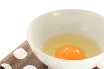 raw egg in white bowl with copy space