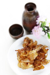 Japanese snack food, dried fish on plate with copy space