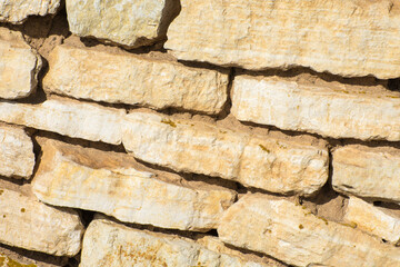 Acient stone wall. Background of old vintage brick wall. Limestone houses.