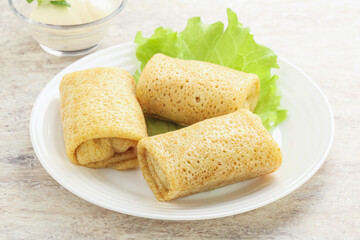 Stuffed pancakes with meat and cream