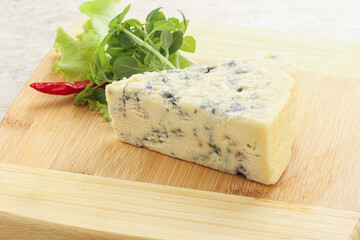 Blue cheese piece over board