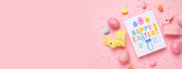 Beautiful Easter composition with greeting card, painted eggs and bunnies on pink background with space for text