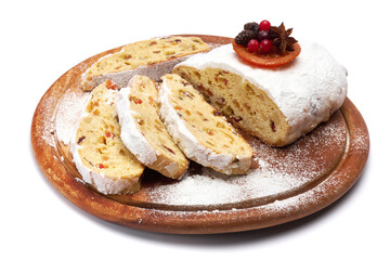 Sliced Traditional Christmas stollen cake with marzipan and dried fruit isolated on white background