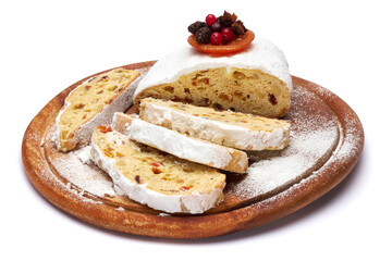 Sliced Traditional Christmas stollen cake with marzipan and dried fruit isolated on white background
