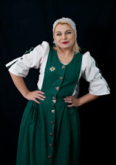 Beautiful cheerful Ukrainian woman in a suit posing on a black background