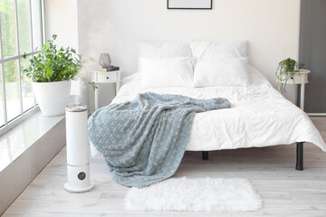 Interior of stylish bedroom with humidifier