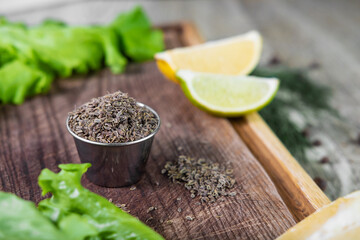 Caraway grain in the jar, vintage wooden background.