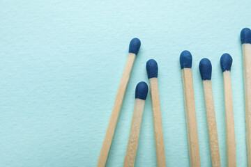 New matchsticks on blue background, closeup