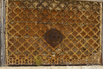 cast iron decoration above an entrance door to an old house in Portimao, Algarve, Portugal