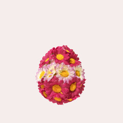Easter eggs made of artificial spring flowers on white background. Square flat lay composition, egg shape pattern, minimal Easter celebration concept