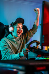 Pro Gamer Man Win Car Racing Online Video Game and Cheer Up with Fist Gesture © ProstoSvet