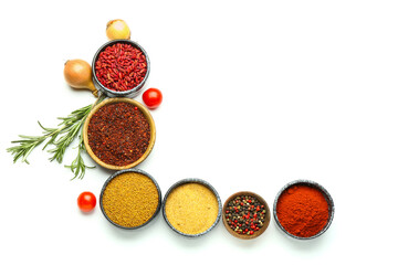 Composition with bowls of spices and vegetables on white background