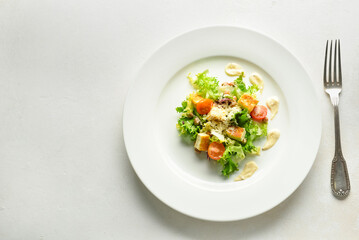 Plate of tasty vegan Caesar salad on white background