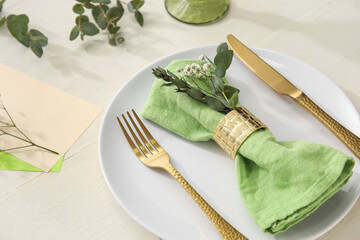 Stylish simple table setting with flowers on light wooden background, closeup