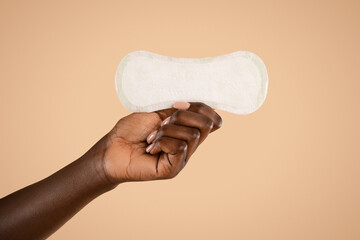 Unrecognizable black woman hand holding pad, closeup