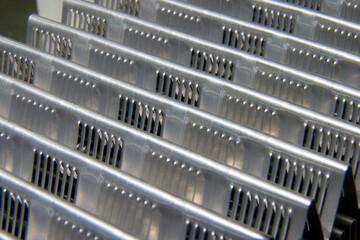 shiny metallic waves of bent metal. aluminum stamping in production