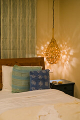 Lamp with orange light on bed and pillow in home room. bedroom of luxury hotel. interior furniture living house concept.