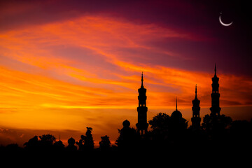 Ramadan, Eid ai-fitr,New year Muharram islamic religion Symbols with Mosques Dome silhouette on dark gold twilight sky in night with Crescent Moon on sunset. arabic,Eid al-adha,mubarak  Muslim concept