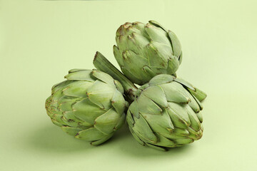 Obraz premium Concept of healthy food with artichoke on green background