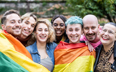 Group of young activist for lgbt rights with rainbow flag, transgenders, homosexual, queers diverse...