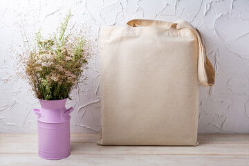 Rustic tote bag mockup with wild grass in the pink can
