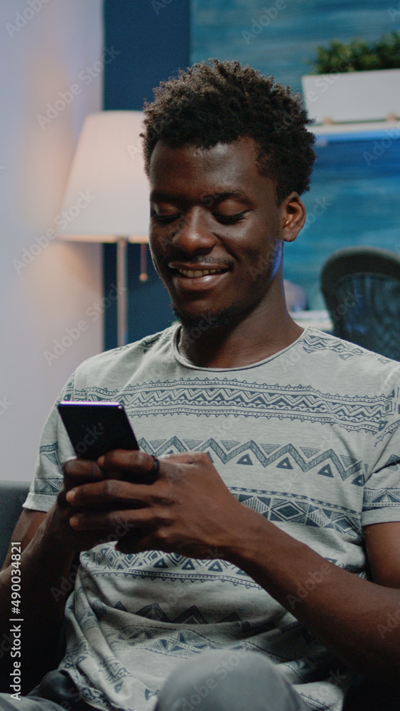 Poster african american man smiling and using smartphone to text messages for online remote work. black ent