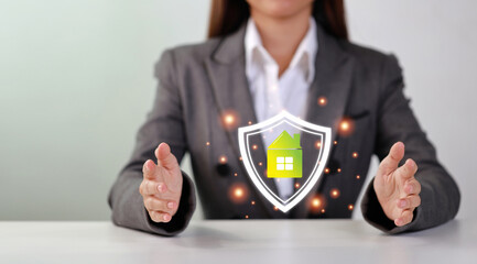 Attractive professional female hands in classic suit show protecting something on table. Businesswoman sitting with white background. Property insurance and security concept