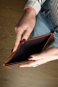 Woman looking an empty wallet. 