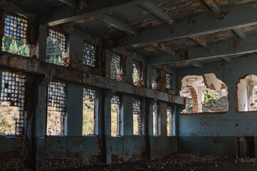 Abandoned ruins of an industrial building. The concept of destruction and demolition.