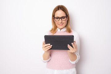 Young business woman holding tablet standing isolated over white background. Business concept.