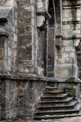 Close-up on the walls of a medieval temple. View of the ancient stone wall covered with thin layer of moss.