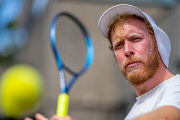 tennis player, swinging at a tennis ball, close up, while sweating, in melbourne australia.