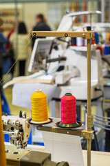 Colorful Spools of Thread on Sewing Equipment, nobody. Fabric and Textile Industry, Embroidery...