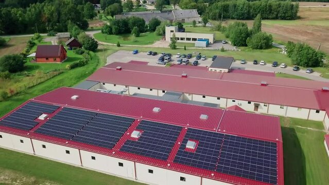 Rooftop and yard with solar panels at small factory (approx. 700 panels with 250 kW power)