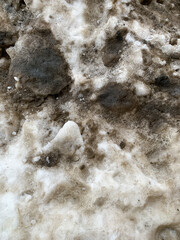 Dirty road in spring, wet tiles, dirty snow