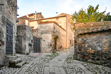 A narrow street among the old stone houses of the oldest district of the city of Caserta Vecchia, Italy.