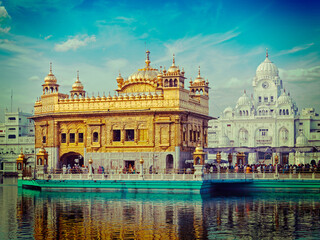 Vintage retro effect filtered hipster style image of famous indian toursit landmark and sacred pilgrimage site - Sikh gurdwara Golden Temple (Harmandir Sahib). Amritsar, Punjab, India