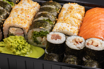 Japanese sushi food. Maki ands rolls with tuna, salmon, shrimp, crab and avocado. Top view of assorted sushi, all you can eat menu. Rainbow sushi roll, uramaki, hosomaki and nigiri