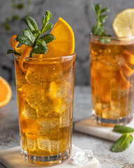 Refreshing iced tea with orange slices and mint