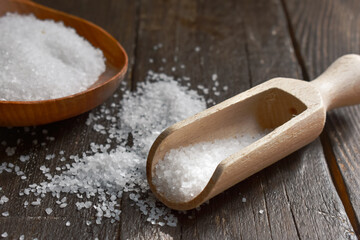 Fototapeta na wymiar kitchen salt on wooden Table Background (table salt )