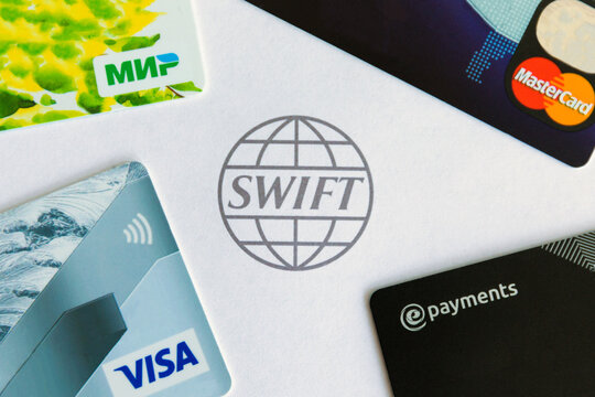 March 1, 2022 - Saint-Petersburg, Russia. Disabling Russia from Swift. Bank cards and swift system logo