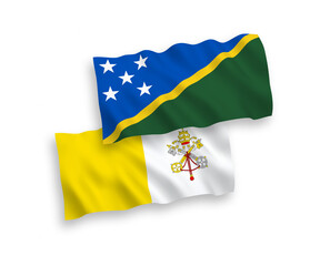 National vector fabric wave flags of Solomon Islands and Vatican isolated on white background. 1 to 2 proportion.
