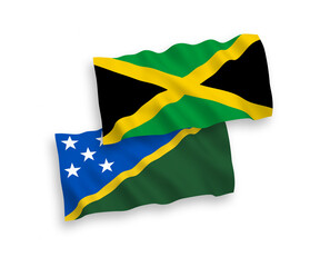 National vector fabric wave flags of Solomon Islands and Jamaica isolated on white background. 1 to 2 proportion.