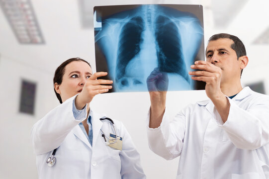 Shot of two doctors discussing the results of an X-ray at hospital