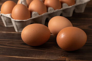 Happy Easter. Easter eggs. Chicken brown eggs closeup top view On the table. A carton crate of fresh brown eggs. Organic chicken eggs in a egg carton.