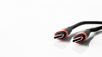 Two red-black usb type-c connectors on a light background. Minimalism. A modern way to connect,...