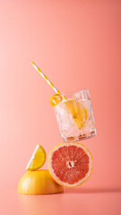 Balancing composition with grapefruit and glass of cocktail