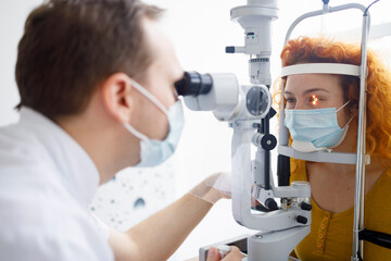 A female patient and her doctor during an eye examination in a professional eye clinic