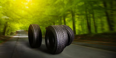 Car tire on summer road. Banner or panorama.